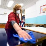 A cleaner sanitises a classroom at the Piero Gobetti high school in Turin