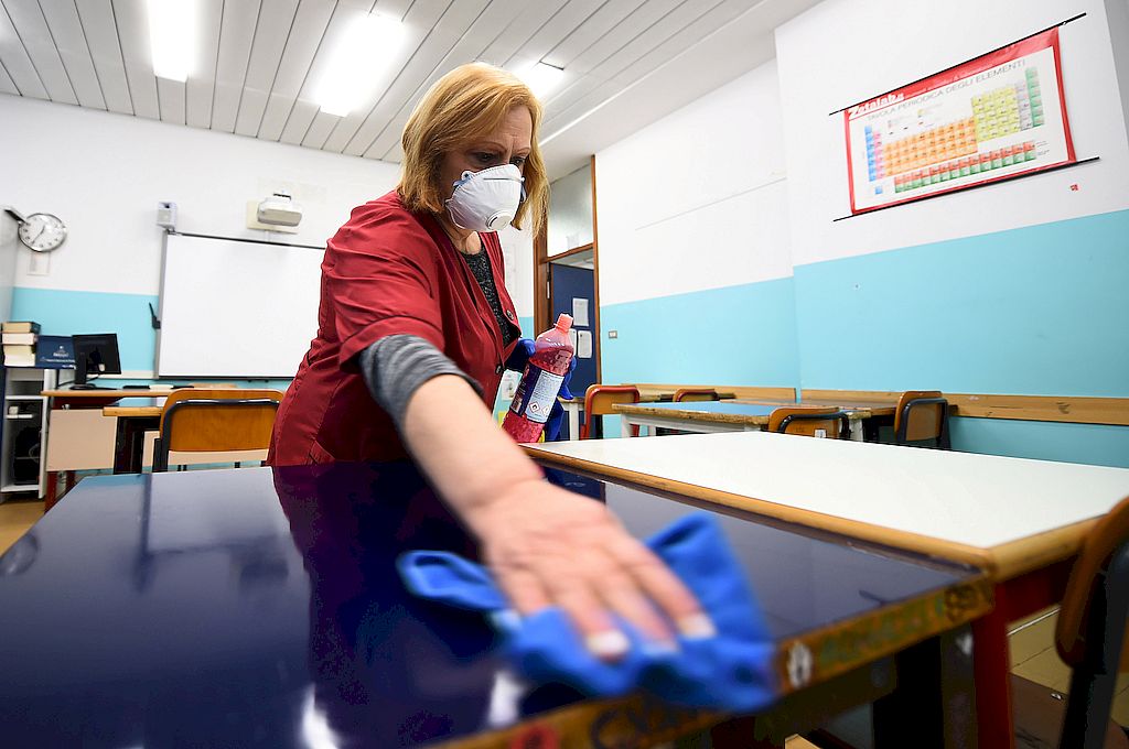 A cleaner sanitises a classroom at the Piero Gobetti high school in Turin, as part of measures to try and contain a coronavirus outbreak, Italy, March 2, 2020.  REUTERS/Massimo Pinca